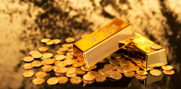 Gold ingots and coins stock photo