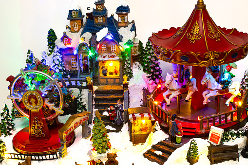 Miniature Christmas village  with carousel, toy shop and ferris wheel