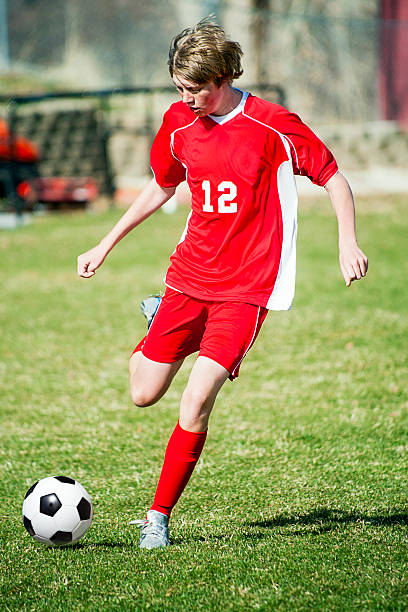 Soccer Controlled Kick Red Uniform stock photo