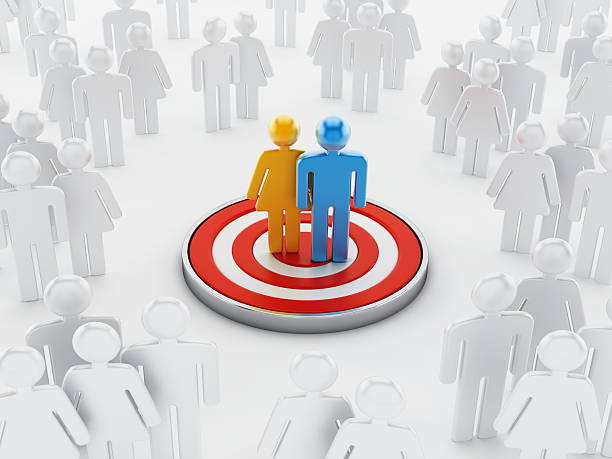 Target audience Colored figures standing at the center of target among white ones.Similar images: niche photos stock pictures, royalty-free photos & images