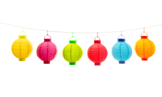 Subject: A row of Chinese lanterns in various color hanging on a string. Isolated on white background.