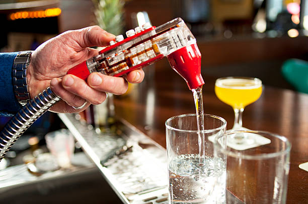 Drink Dispenser Pouring Drink from Dispenser in a Bar. change dispenser stock pictures, royalty-free photos & images