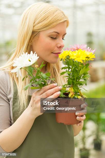 Young Florist Smelling Flowers Stock Photo - Download Image Now - Adult, Adults Only, Botany