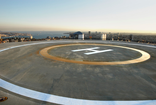 Empty Helipad On The Roof Of Building With City Skyline