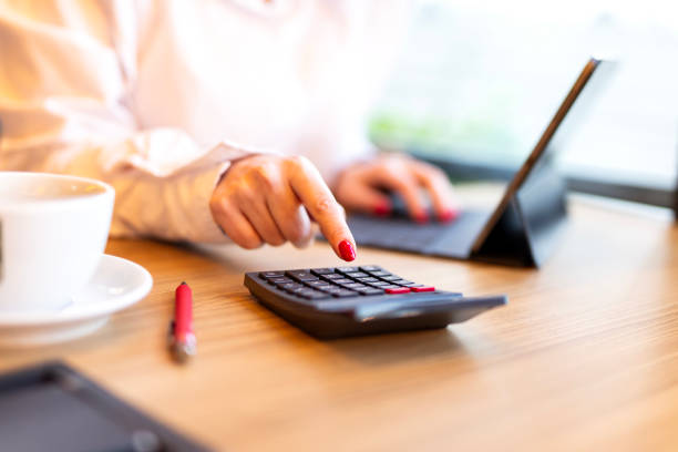 istock Confident young female financial advisor writing on diary while sitting with laptop at desk in office 1724733848