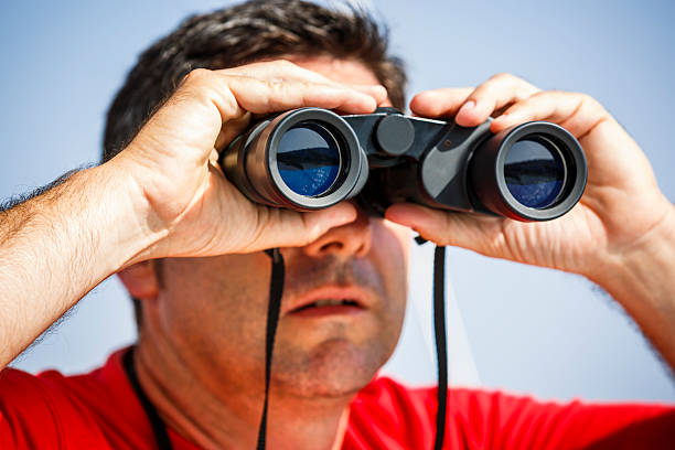istock Sailor with binoculars on sailboat 172473646