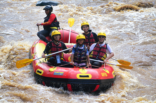 Magelang, Indonesia - May 15, 2022: Tourists doing white water rafting on the Elo River