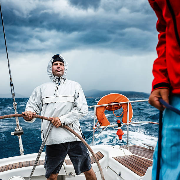 istock Happy skipper sailing on sailboat in bad weather 172473711