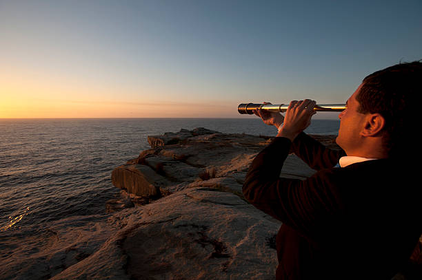 istock Businessman looking to the future with telescope 172474077