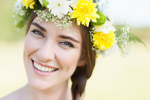 A gorgeous young woman with a flower wreath on her head..