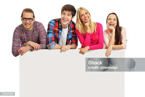 Foto de Jovem Feliz Com Um Banner e mais fotos de stock de Aluno de Universidade - Aluno de Universidade, Fundo Branco, Grupo de Pessoas