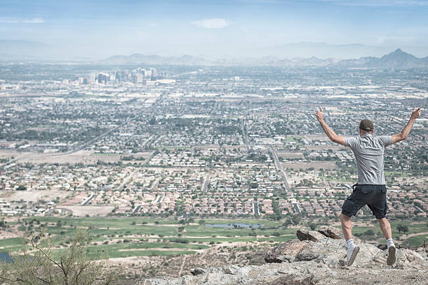 istock jumping on top of the mountain 172474643