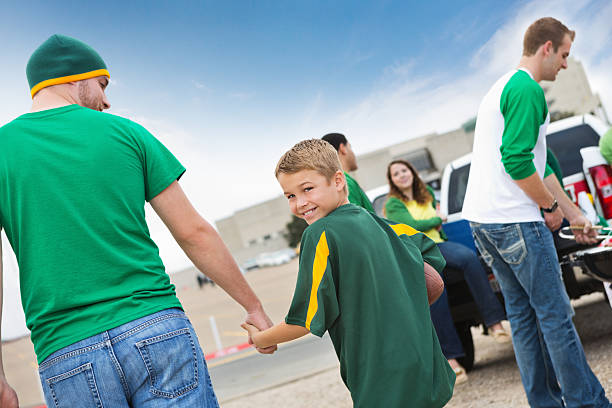 Little boy with father at football stadium tailgate party Little boy with father at football stadium tailgate party people family tailgate party outdoors stock pictures, royalty-free photos & images