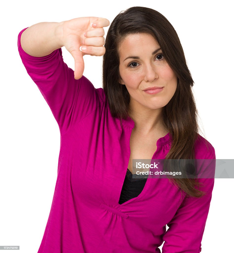 Woman Gives Thumbs Down Portrait of a woman on a white background. 20-29 Years Stock Photo