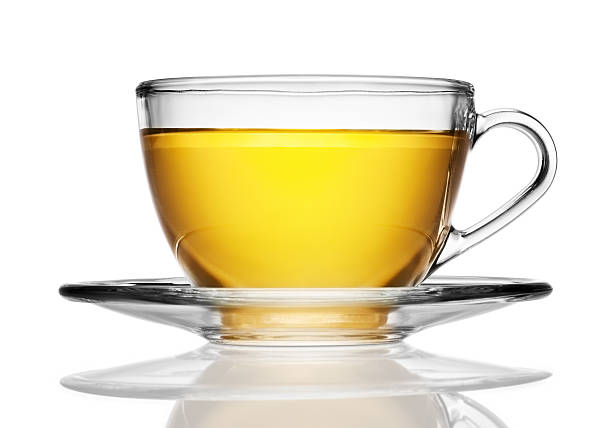 vetro tazza e piattino di tè alle erbe isolato su bianco - glass tea herbal tea cup foto e immagini stock