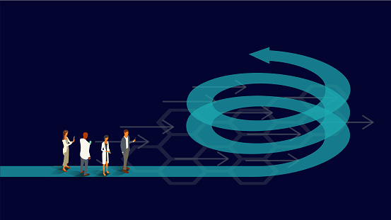 Four healthcare professionals stand on an arrow forming the shape of an upward helix, spiral, or coil, illustrating the concept of a virtuous cycle. Translucent teal and turquoise arrows appear on an ultra-dark background within a 16x9 landscape artboard. Vector shapes, including people, are presented in isometric projection using a limited color palette. People are dressed as healthcare professionals and use internet-enabled devices.