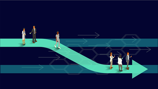 Six healthcare professionals stand on an arrow that shifts from one parallel line to another, illustrating the concept of a realignment. Translucent teal and turquoise arrows appear on an ultra-dark background within a 16x9 landscape artboard. Vector shapes, including people, are presented in isometric projection using a limited color palette. People are dressed as healthcare professionals and use internet-enabled devices.