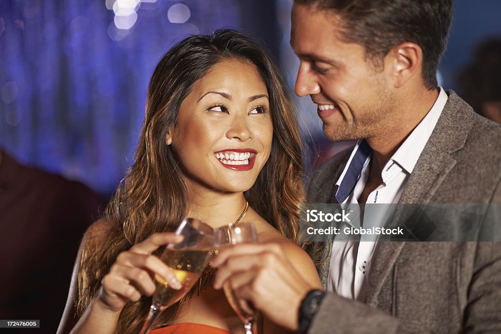 It's good to meet you Young people flirting and having a good time over some champagne at a nightclub 20-29 Years Stock Photo