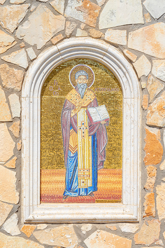 Representative figure of the Greek Orthodox Church of Ayia Napa.  mosaics outside the church.