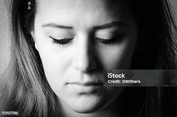 Sad Young Woman Looking Down Black And White Portrait Stock Photo - Download Image Now