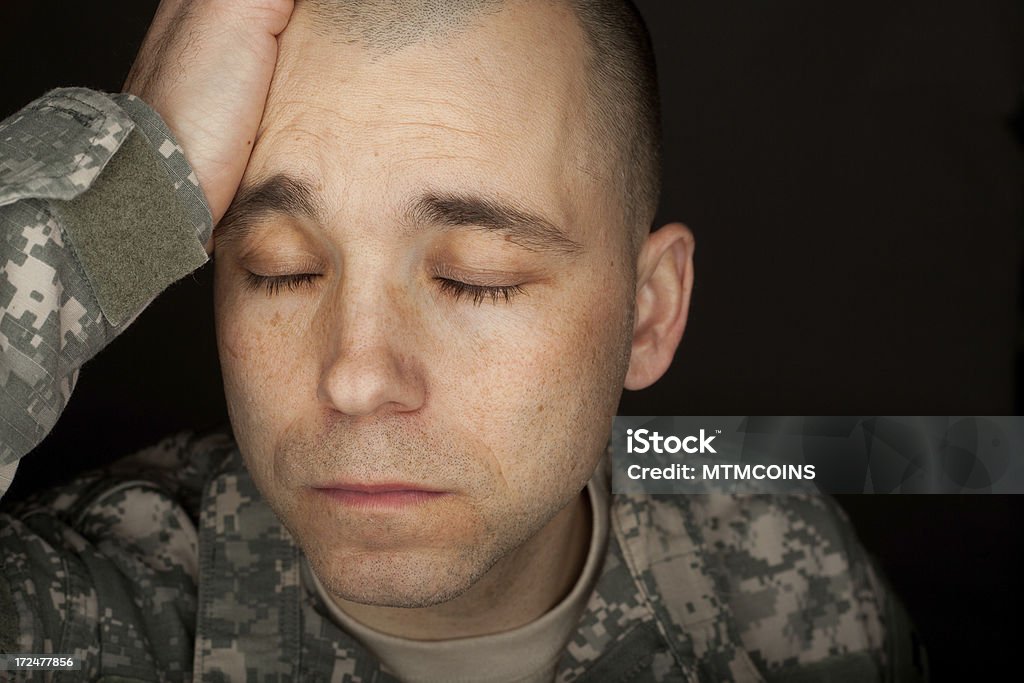 Soldier Suffering A portrait of a soldier suffering from depression or PTSD. Very dramatic lighting used to help enhance the depressing mood. Post-traumatic stress disorder Stock Photo
