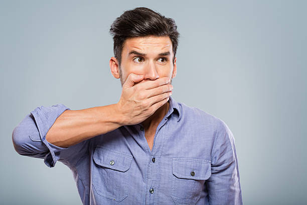 istock Young man covering his mouth 172477897