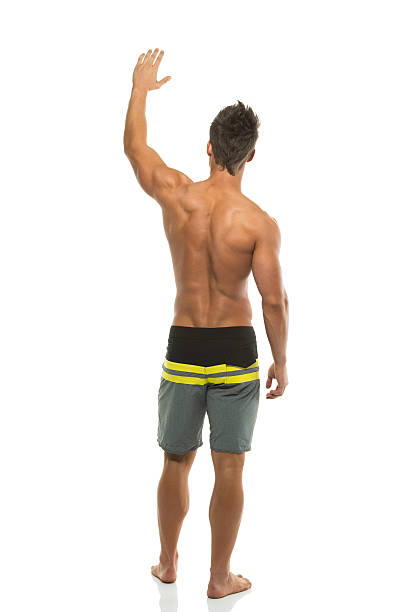 Rear view of a man waving hand stock photo