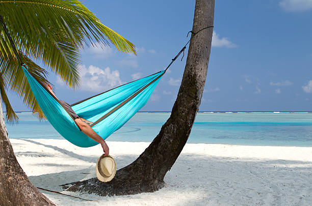istock Young adult having a nap in a beach hammock 172478819