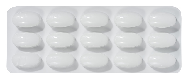 Oval tablets in white plastic packaging, top view
