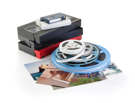 Video cassettes, photographs and film reels on white background with DVD, Concept for DVD transfer. 