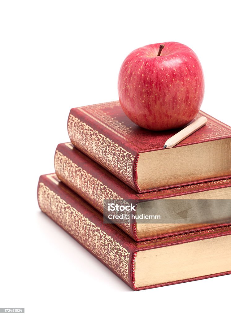 Apple on a Stack of Book isolated on white background Ancient Stock Photo