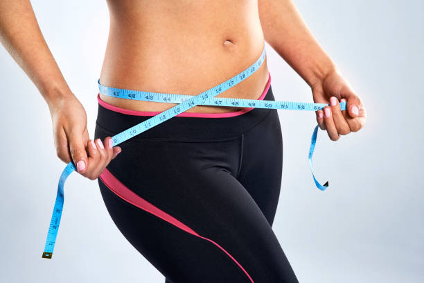 Measuring her waistline stock photo