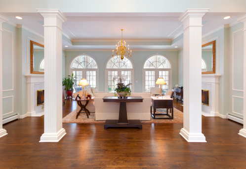 Grand Foyer and Living Room With White Pillars, Half-Round Windows, Tray Ceiling.