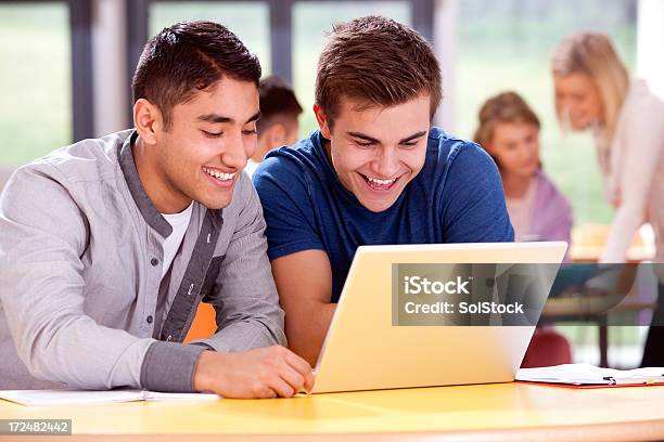 Teenagers Using Laptop Stock Photo - Download Image Now - Adult Student, Book, Casual Clothing