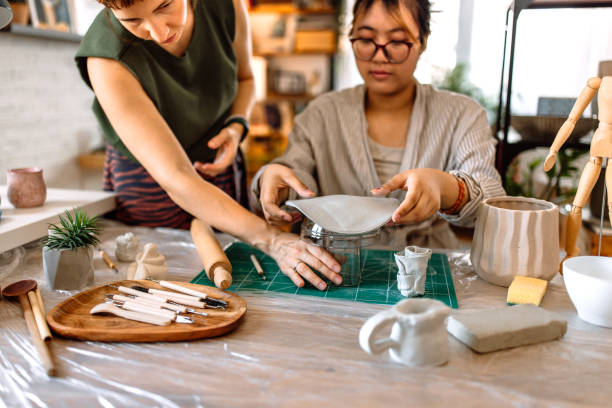 istock Two women working in home pottery workshop 1724827271