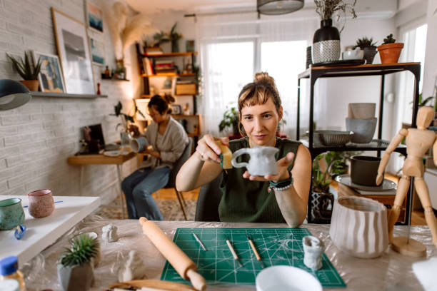 istock Artist woman making clay kettle in a home pottery workshop 1724828654