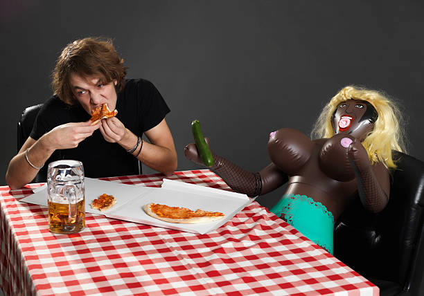 dinner with doll dinner with doll.split a pizza with his mistress plastic blow up doll stock pictures, royalty-free photos & images