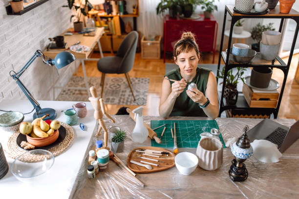 istock Sculptor woman making clay sculpture in a home pottery workshop 1724831124