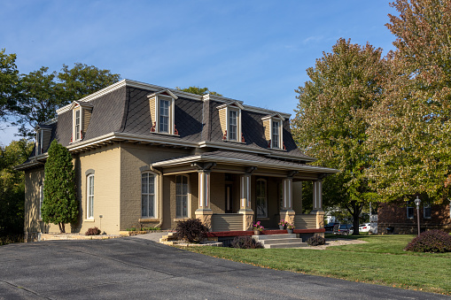 Mankato, Minnesota, USA - September 30, 2023: Landscape view of the William Irving House, a unique well preserved historic house built in 1873, in Second Empire style architecture, including a bellcast mansard roof with dormers. The house was listed in the National Register of Historic Places in 1980.