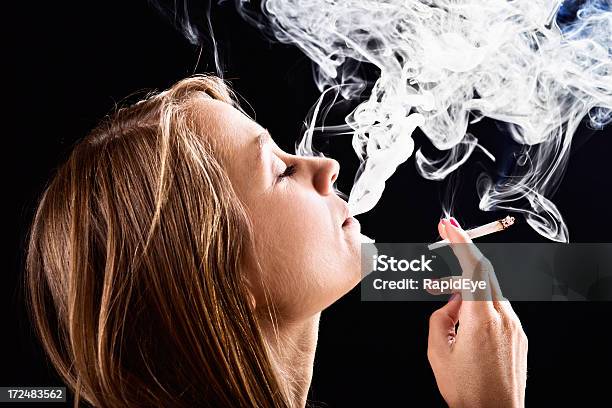 Beautiful Blonde Dreamily Smoking Handrolled Marijuana Joint Stock Photo - Download Image Now