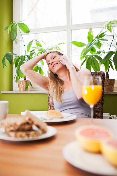 istock Woman making a phone call during breakfast. 172484125