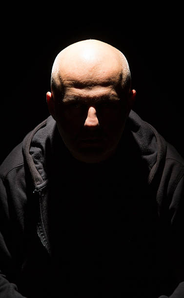 man in black a man alone in the dark see my skinhead haircut stock pictures, royalty-free photos & images