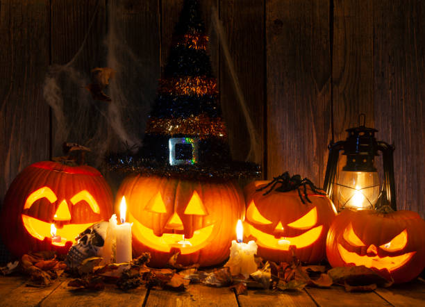 istock Halloween Jack-o-Lantern Pumpkins on rustic wooden background 1724846919