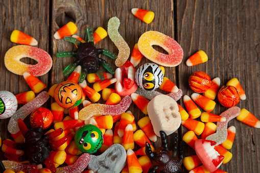 Mixed Halloween candy on wooden rustic background