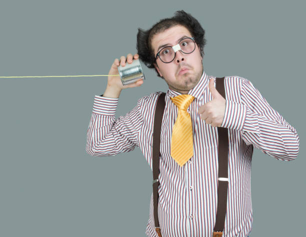 istock Nerd male listening through a tin can phone 172484762