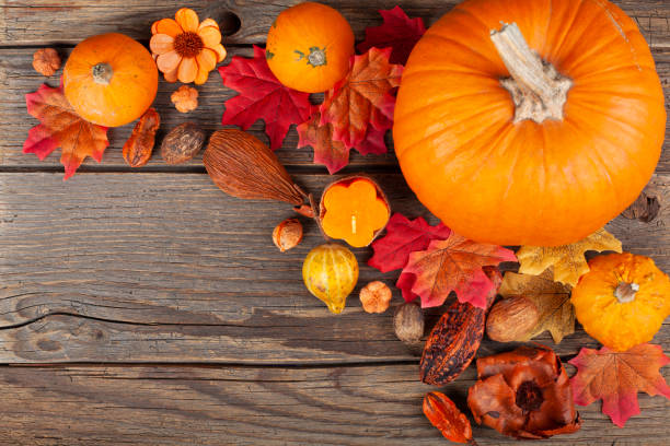 istock Autumn leaves and pumpkin on rustic wooden table 1724848503