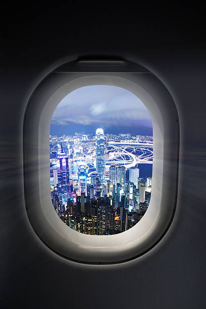istock City at night through airplane window 172485050