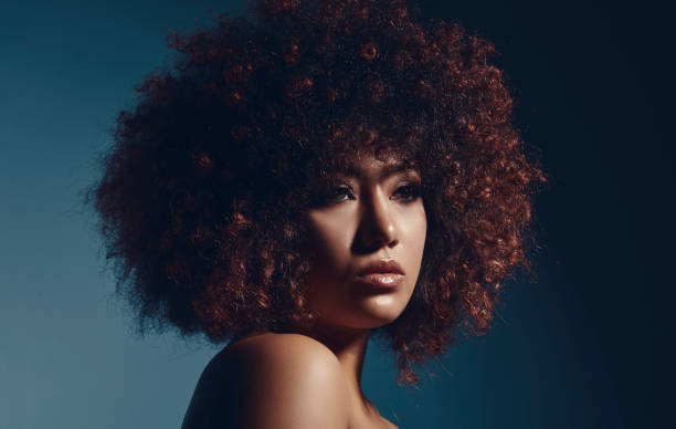 istock Curly-haired mixed-race young woman. 1724850676