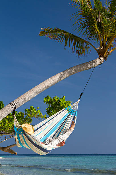 istock Young adult having a nap in a hammock 172485106