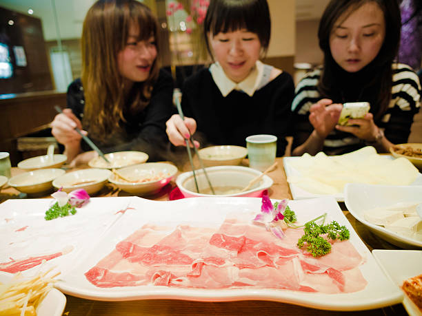 Enjoy shabushabu 3 friend have dinner chinese ethnicity china restaurant eating stock pictures, royalty-free photos & images